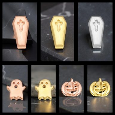 A collection of metallic Halloween-themed charms: coffins, ghosts, and pumpkins.