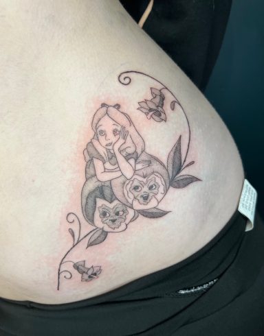 Tattoo featuring a girl with two cats surrounded by floral elements and butterflies.